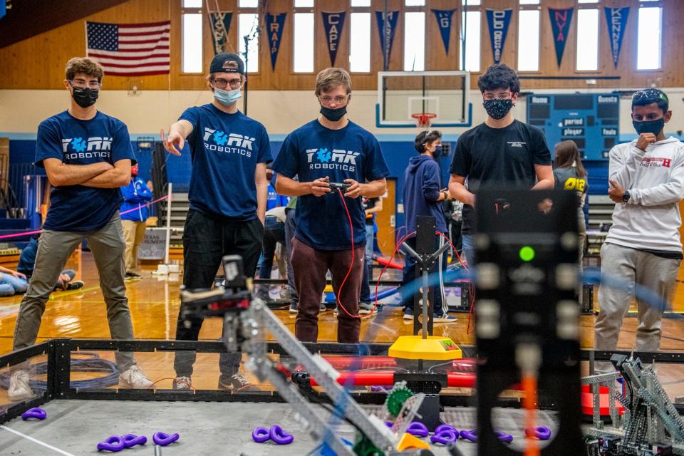 From left to right, teammates Hunter Pruett, 17, Cam Dalton, 17, and Ben Boksanski, 18, compete in a qualifying match at the VEX Robotics Tournament hosted at York High School on Saturday, Nov. 13, 2021.