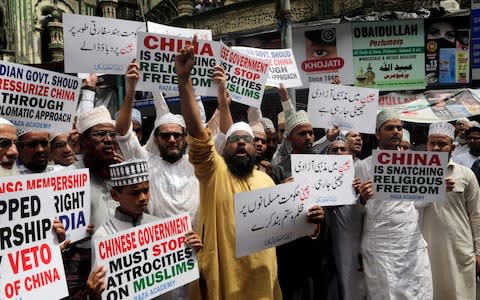 World concern: Indian Muslims shout slogans during a protest against the Chinese government, in Mumbai, India - Credit:  Rajanish Kakade/AP