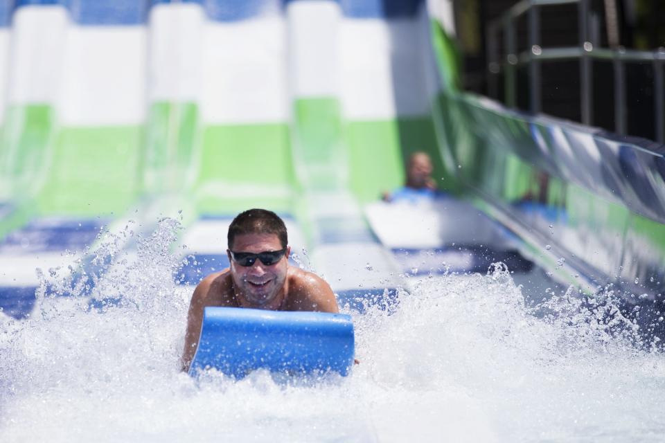 Chad McDermott of Seneca Falls rides the Hydro Racer with his kids at Seabreeze Amusement Park on June 7, 2015.