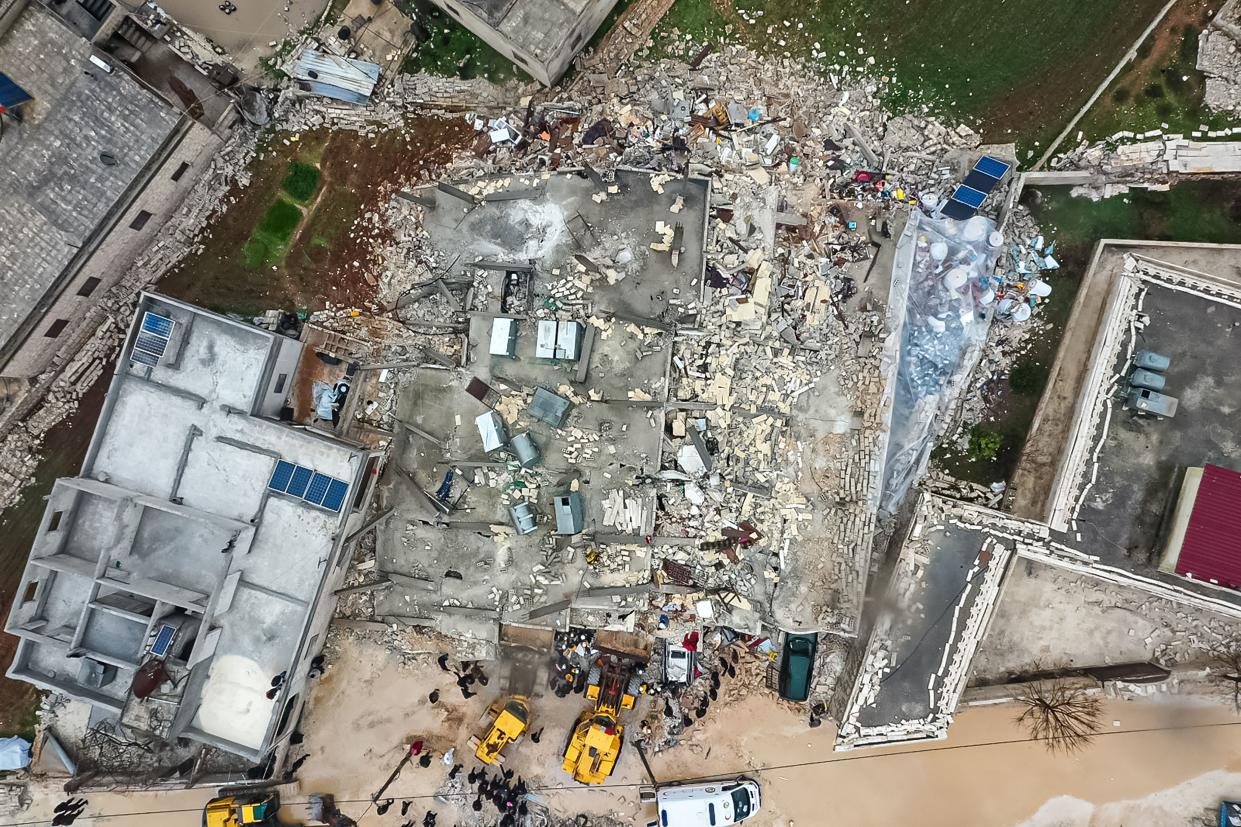 An aerial view of rescue teams searching for victims in the rubble.