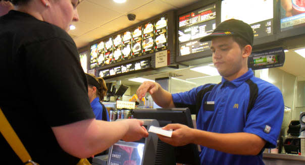 Florida Miami Homestead McDonald's fast food restaurant inside counter employee Hispanic man cashier giving receipt change custo