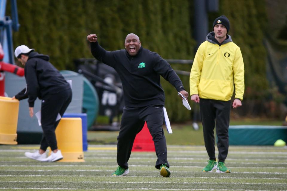 Oregon running backs coach Carlos Locklyn calls to players during practice with the Ducks Tuesday, April 4, 2023. 