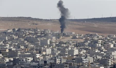 Smoke rises after an U.S.-led air strike in the Syrian town of Kobani Ocotber 8, 2014. REUTERS/Umit Bektas