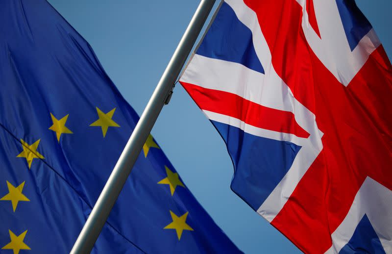 FILE PHOTO: European Union and British flags flutter in front of a chancellery ahead of a visit of British Prime Minister Theresa May in