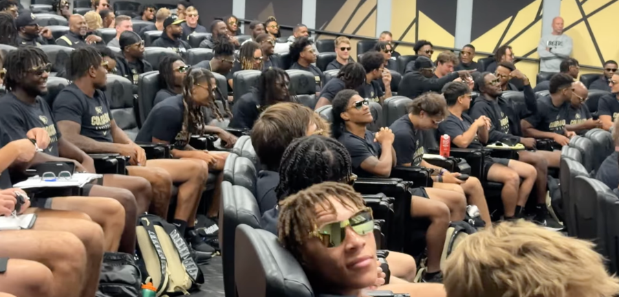 Colorado Buffaloes football players wear signature sunglasses handed out by coach Deion Sanders after in response to a dig against his accessories by rival Colorado State coach Jay Norvell. (via YouTube screenshot)