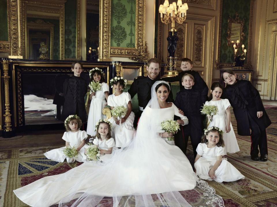 <p>In <a href="https://www.townandcountrymag.com/society/tradition/a20747996/meghan-markle-prince-harry-kate-middleton-official-royal-wedding-portraits-comparison/" rel="nofollow noopener" target="_blank" data-ylk="slk:an official royal wedding portrait taken by Alexi Lubomirski;elm:context_link;itc:0;sec:content-canvas" class="link ">an official royal wedding portrait taken by Alexi Lubomirski</a>, Prince Harry and Meghan Markle pose with their page boys and bridesmaids, including a very smiley Prince George.</p>