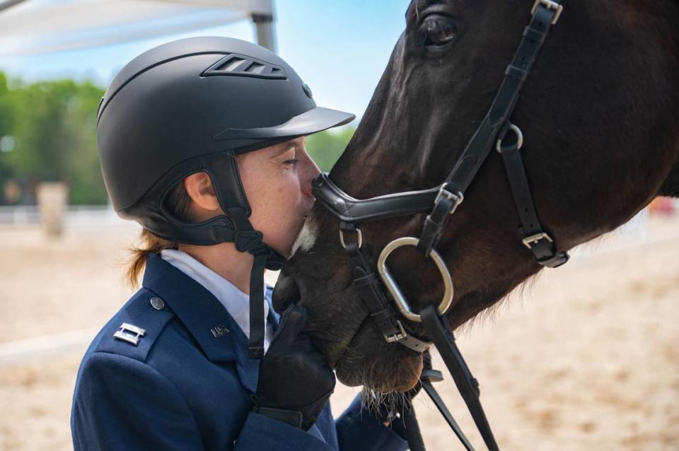 U.S. Air Force Capt. Magin Day, Operational Medicine Readiness Squadron flight commander, kisses Rumor, her horse, after completing the first day events of the two-day 2023 Queeny Park Equestrian Events Horse Trials at the National Equestrian Center in St. Louis. The first day of events consisted of dressage and stadium jumping.