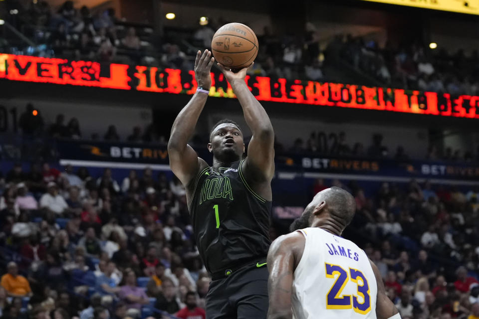 New Orleans Pelicans forward Zion Williamson (1) shoots over Los Angeles Lakers forward LeBron James (23) in the second half of an NBA basketball game in New Orleans, Sunday, April 14, 2024. The Lakers won 124-108. (AP Photo/Gerald Herbert)