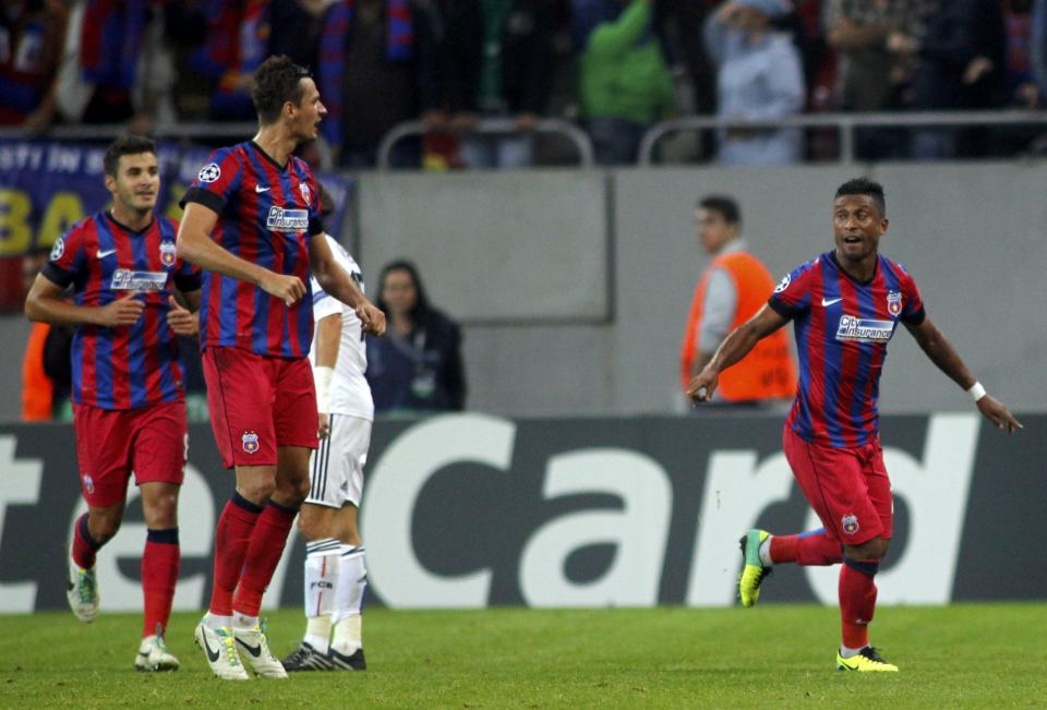 Leandro Tatu of Steaua Bucharest (R) celebrates his goal against Basel with team mates during their Champions League soccer match at the National Arena in Bucharest October 22, 2013. REUTERS/Bogdan Cristel (ROMANIA - Tags: SPORT SOCCER)