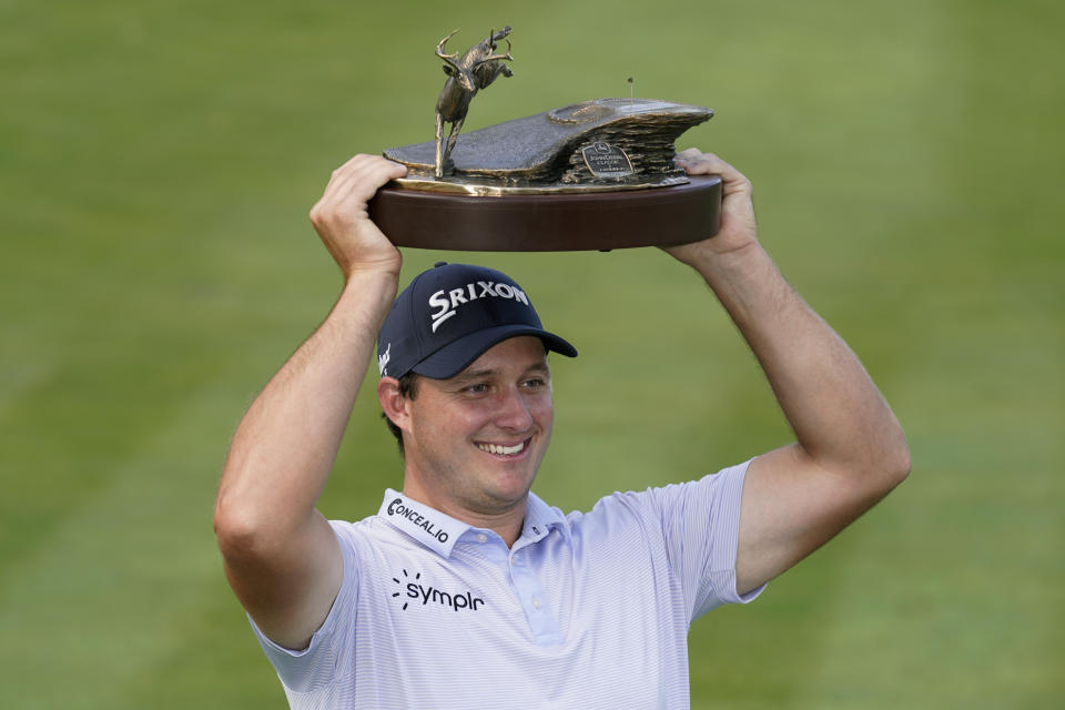Sepp Straka, of Austria, holds the trophy after winning the John Deere Classic golf tournament, Sunday, July 9, 2023, at TPC Deere Run in Silvis, Ill. (AP Photo/Charlie Neibergall)