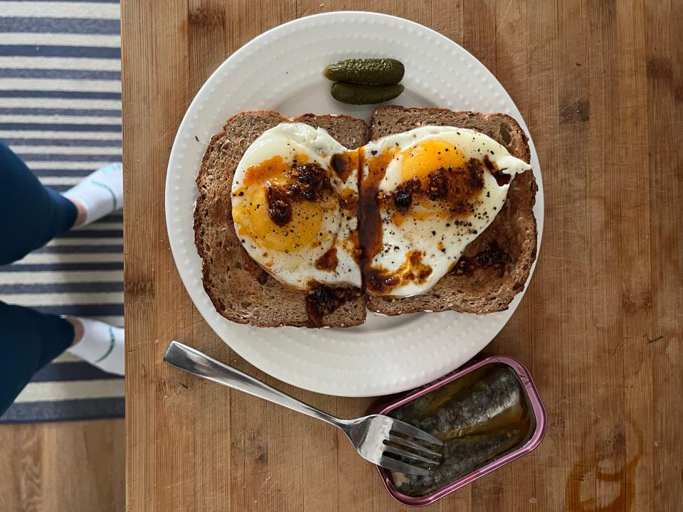 Toast with eggs, chili oil, and tinned sardines.