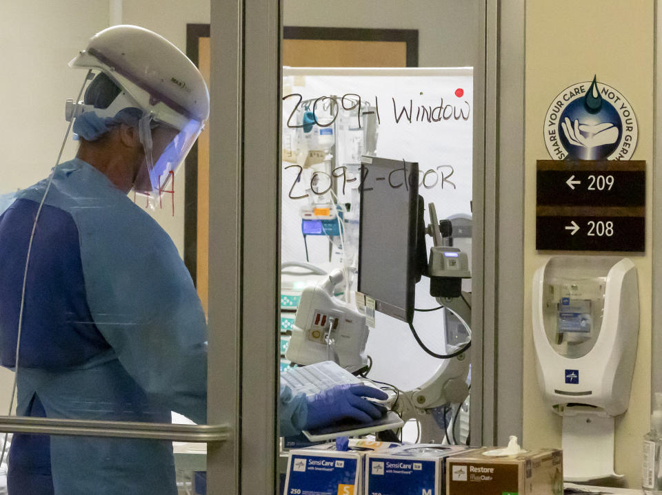 In this Thursday, Aug. 19, 2021, photo, a staff member works in the Critical Care Unit at Asante Three Rivers Medical Center in Grants Pass, Ore. The hospitalization rate of unvaccinated COVID-19 is breaking records and squeezing hospital capacity, with several running out of room to take more patients.(Mike Zacchino/KDRV via AP, Pool)