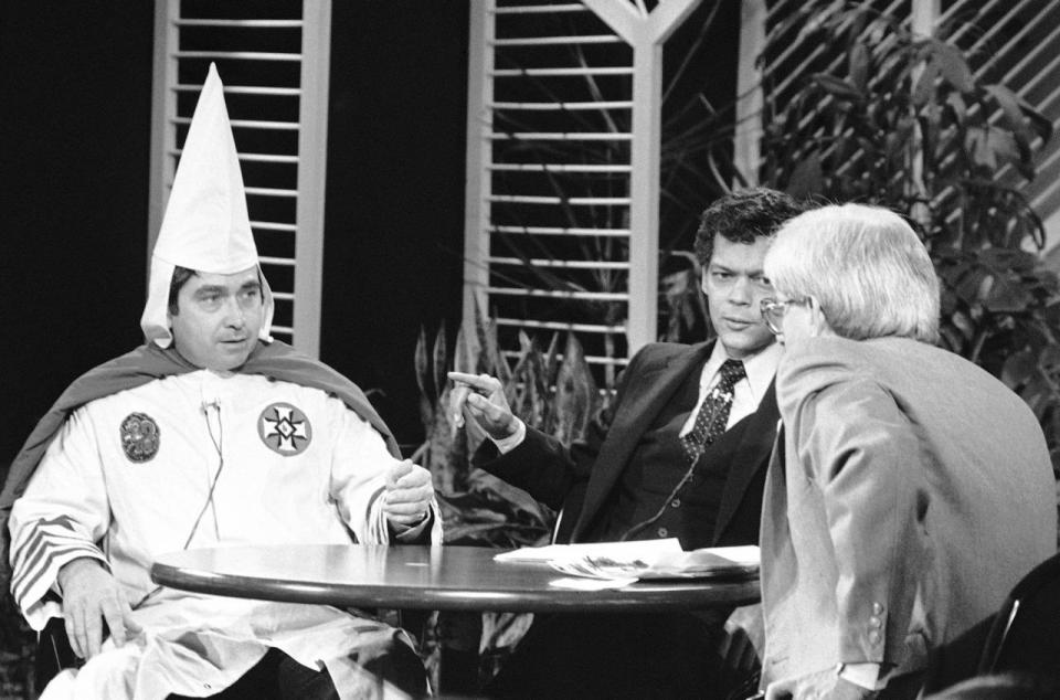 <p>Bill Wilkinson in robe, Imperial Wizard of the Invisible Empire of the Ku Klux Klan appearing on Phil Donahue TV show, Dec. 4, 1980 in Chicago with Georgia State Sen. Julian Bond. (Photo: Charles Knoblock/AP) </p>