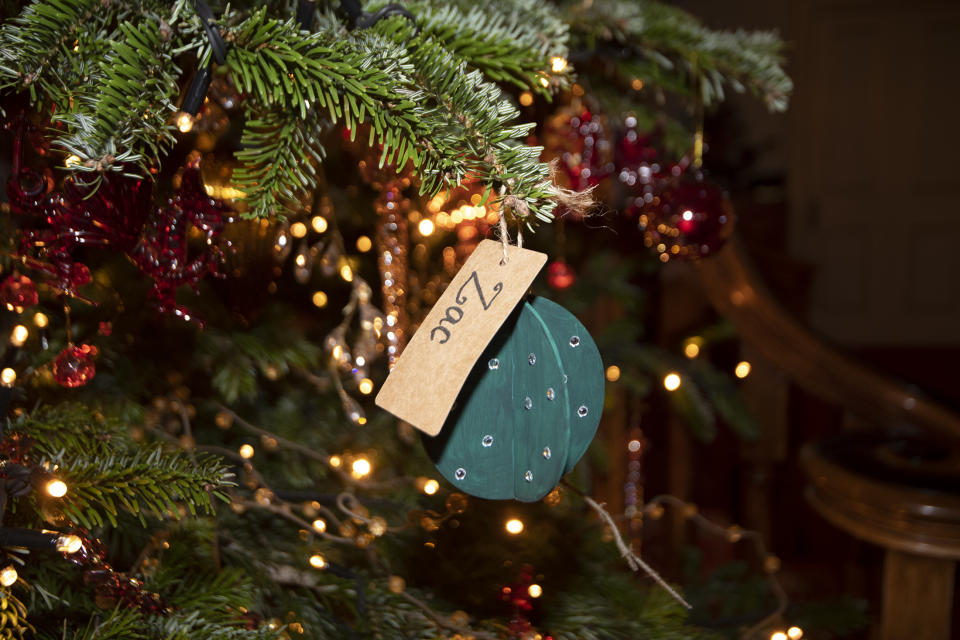 LONDON, ENGLAND - DECEMBER 16: Captain Charles Ross Assistant Equerry with the Clarence House Xmas tree and some of the baubles as the Duchess of Cornwall decorates the Clarence House Christmas Tree virtually with children from Helen & Douglas House Hospice, on December 16, 2020 in London, England. (Photo by Eddie Mulholland - WPA Pool/Getty Images)