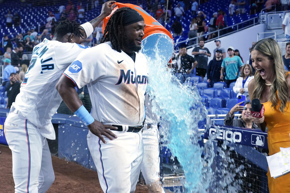 Miami Marlins' Jazz Chisholm Jr. (2) pours a bucket of Gatorade on Josh Bell at the end of the 12th inning of a baseball game against the Philadelphia Phillies, Wednesday, Aug. 2, 2023, in Miami. The Marlins defeated the Phillies 9-8. Bell was recently traded by the Cleveland Guardians. (AP Photo/Marta Lavandier)