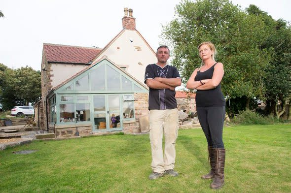 The Nicholsons outside their home.