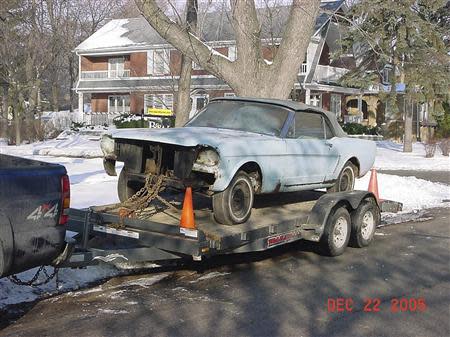 Gail Wise's Skylight Blue 1964 1/2 Ford Mustang convertible is loaded onto a trailer before its restoration in Park Ridge, Illinois December 22, 2005. Gail Wise, then using her maiden name of Gail Brown, made the first known retail purchase of a Mustang on April 15, 1964, two days before the model went on sale. The car was garaged in 1979, until its restoration 27 years later by Tom Wise. REUTERS/Courtesy of Tom and Gail Wise/Handout via Reuters