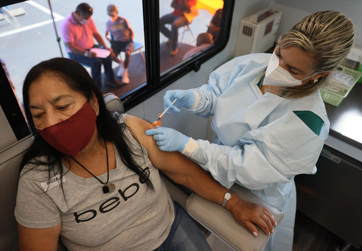 Ilcira Roca receives a Pfizer-BioNTech COVID-19 vaccine from Yelany Lima, a Registered Nurse, at the UHealth's pediatric mobile clinic on May 17, 2021 in Miami, Florida. (Joe Raedle/Getty Images)