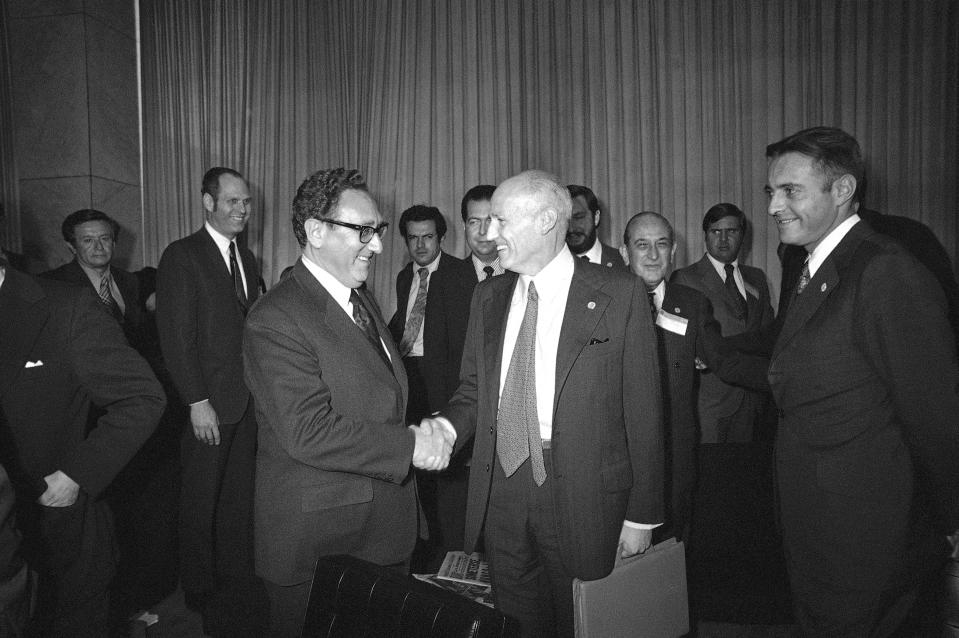 FILE - U.S. Secretary of State Henry Kissinger shakes hands with Chile's Foreign Minister Ismale Huerta Diaz during break in Latin Foreign Ministers Conference in Mexico City, Feb. 22, 1974. Leftists in Chile were tortured during the military dictatorship of Gen. Augusto Pinochet and in Argentina, many were "disappeared" by members of the brutal military dictatorship that held detainees in concentration camps. It all happened with the endorsement of Henry Kissinger, the former U.S. secretary of state. Many countries were scarred deeply during the Cold War by human rights abuses inflicted in the name of anti-communism and where many still harbor a deep distrust of their powerful neighbor to the north. (AP Photo/Ed Kolenovsky, File)