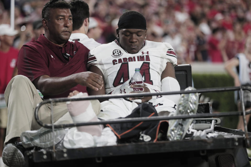 South Carolina linebacker Sherrod Greene (44) is taken off the field on a cart after an injury during the team's NCAA college football game against Georgia on Saturday, Sept. 18, 2021, in Athens, Ga. (Joshua Boucher/The State via AP)