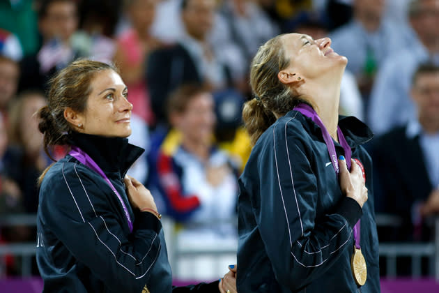 Gold medalists <a href="http://sports.yahoo.com/olympics/beach-volleyball/misty-may-treanor-1134494/" data-ylk="slk:Misty May-Treanor;elm:context_link;itc:0;sec:content-canvas" class="link ">Misty May-Treanor</a> and <a href="http://sports.yahoo.com/olympics/beach-volleyball/kerri-walsh-jennings-1135351/" data-ylk="slk:Kerri Walsh Jennings;elm:context_link;itc:0;sec:content-canvas" class="link ">Kerri Walsh Jennings</a> celebrate on the podium during the medal ceremony for the Women's Beach Volleyball on August 8, 2012 in London, England. (Photo by Jamie Squire/Getty Images)