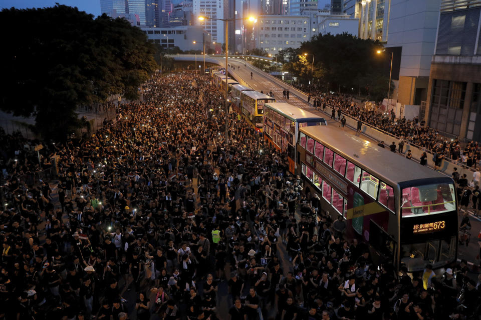 In this Sunday, June 16, 2019, photo, protesters gather on a main road near the Legislative Council as they continuing protest against the unpopular extradition bill in Hong Kong. The largely youth-driven movement challenging Hong Kong's government over an unpopular extradition law is a coalition operating without a clear leadership structure. And that adds to its appeal for supporters disaffected from the moneyed elites who run the former British colony, organizers say. (AP Photo/Kin Cheung)