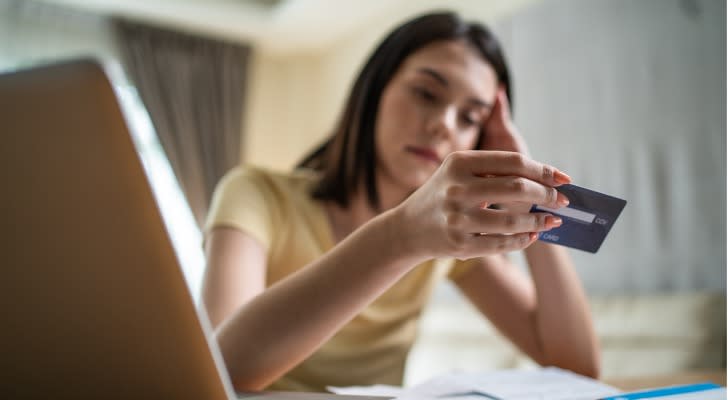 A woman stresses over her credit card debt. 