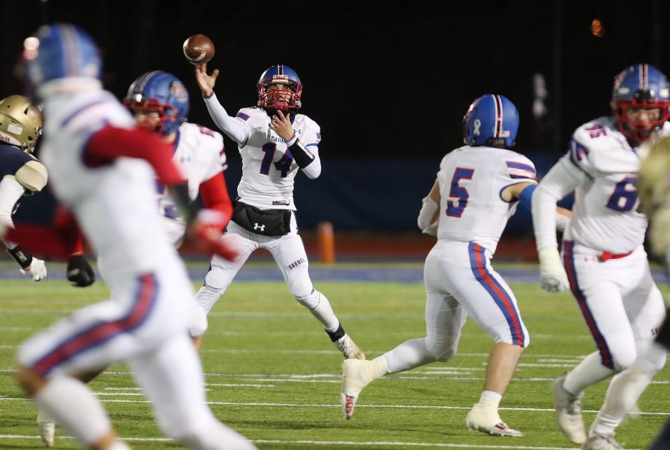 Carmel quarterback Kevin Dall (14) completes a pass to Josh Masi (5) during the Class AA state semifinal at Middletown High School Nov. 27, 2021. Carmel won the game 47-13.