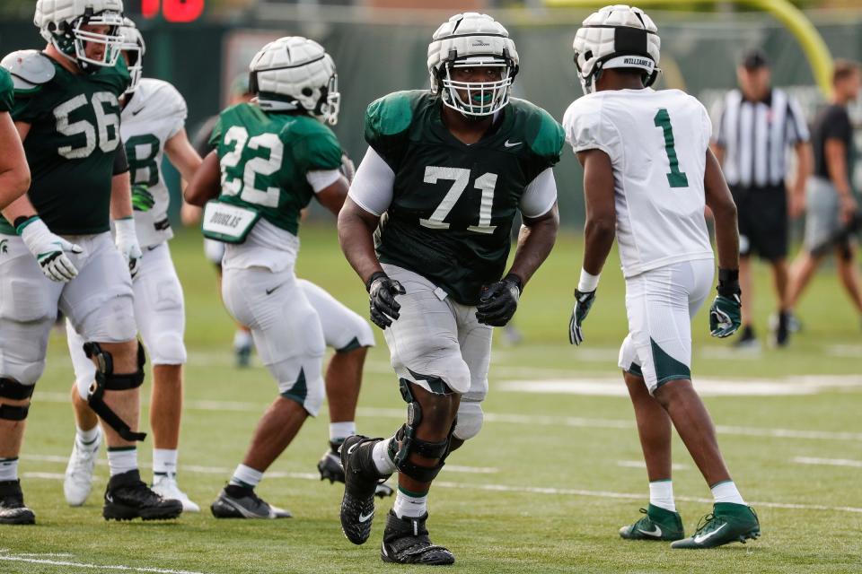 Former Michigan State reserve guard James Ohonba (71), who is transferring to UL to join a depleted Ragin' Cajuns offensive line, takes part in a Spartans practice last August.