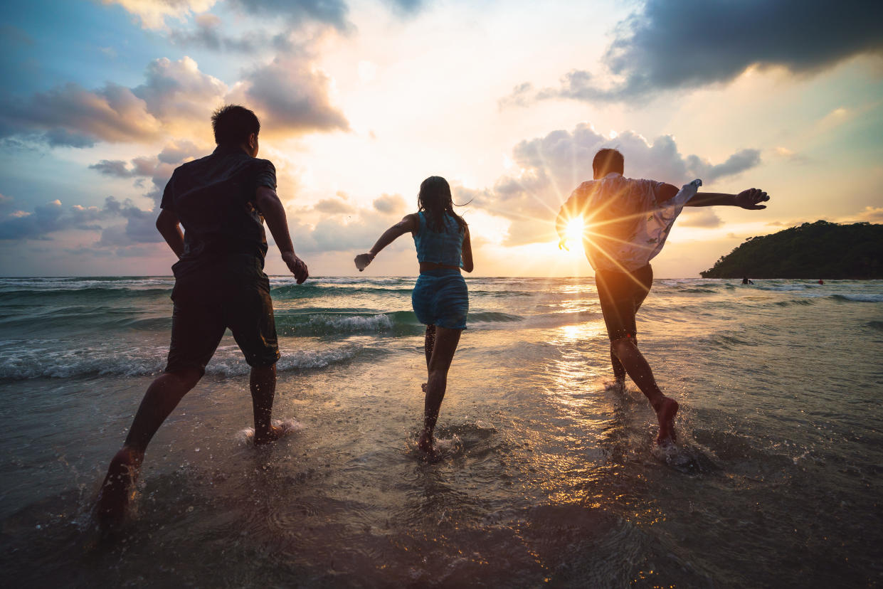 Friends playing on beach, Ko Kut Thailand