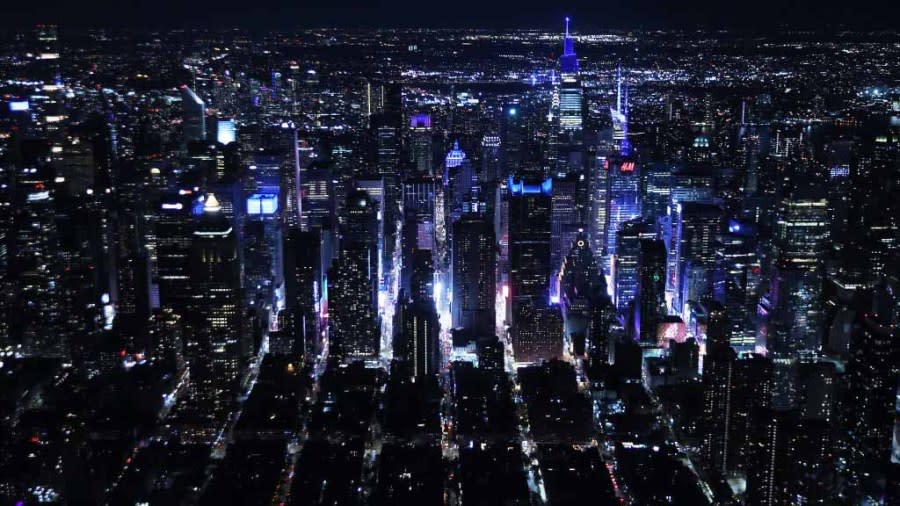 The facades and spires of buildings near NYC’s Times Square are lit up for the 20th anniversary of the 9/11 terror attacks on Sept. 11, 2021. Dozens of buildings participate in the tribute each year. (Photo by Chip Somodevilla/Getty Images)