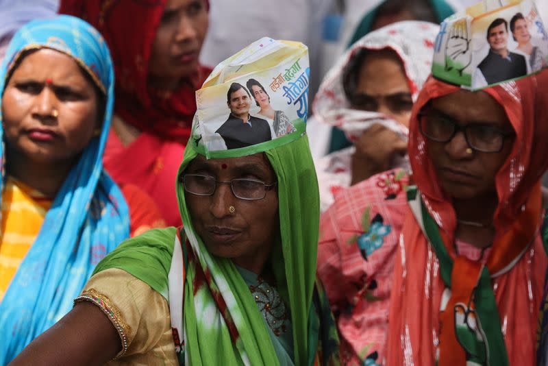 Supporters wear caps with the picture of Rahul Gandhi, a senior leader of India's main opposition Congress party and his sister Priyanka Gandhi Vadra, in Raebareli
