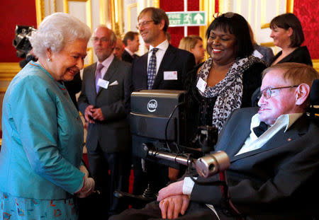 Britain's Queen Elizabeth (L) meets Stephen Hawking during a reception for Leonard Cheshire Disability charity at St James's Palace in London May 29, 2014. Jonathan Brady/Pool via REUTERS/Files