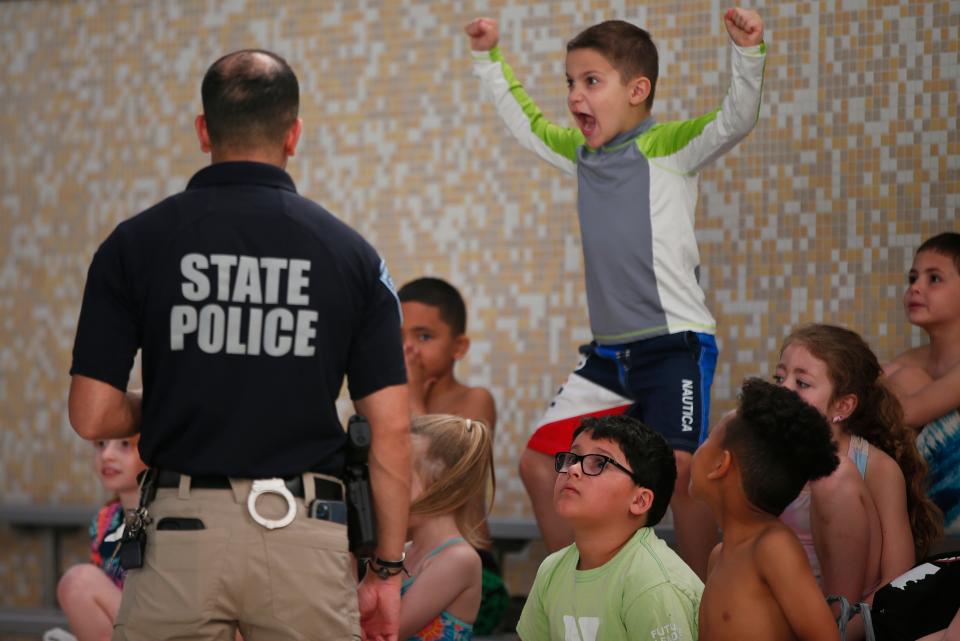 A student is extremely excited that everyone is about to enter the pool during the Water Safety/ Intro to Swimming class hosted by the Mass State Police at the New Bedford YMCA.