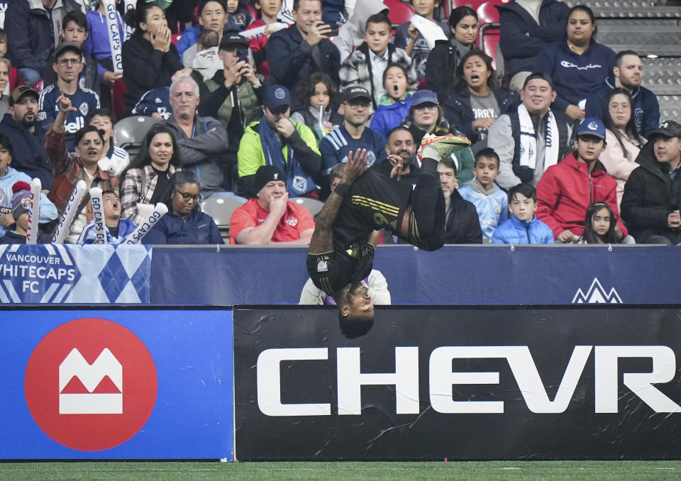 Los Angeles FC's Denis Bouanga flips as he celebrates after his penalty kick goal against the Vancouver Whitecaps during the first half in Game 2 of a first-round MLS playoff soccer match in Vancouver, British Columbia, Sunday, Nov. 5, 2023. (Darryl Dyck/The Canadian Press via AP)