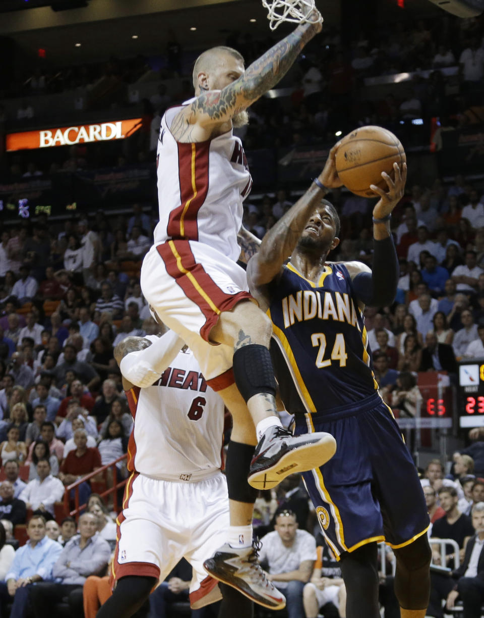 Indiana Pacers' Paul George (24) looks to the basket before being fouled by Miami Heat's Chris Andersen, top, during the first half of an NBA basketball game, Friday, April 11, 2014, in Miami. (AP Photo/Lynne Sladky)