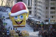 A Sponge Bob Squarepants float makes its way down 6th Ave. during the 87th Macy's Thanksgiving day parade in New York November 28, 2013. REUTERS/Carlo Allegri (UNITED STATES - Tags: ENTERTAINMENT BUSINESS SOCIETY)