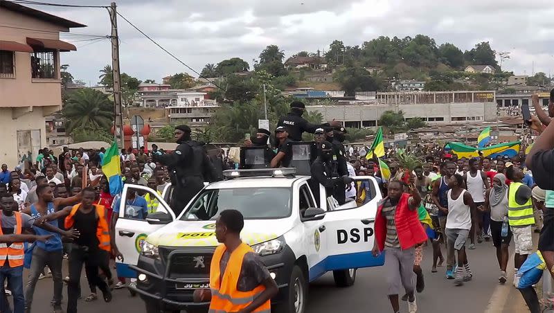 Coup supporters cheer police officers in Libreville, Gabon, on Aug. 30, 2023. Gabon’s opposition leader accused the family of the recently ousted president of engineering his removal from power in order to retain their control in the oil-rich Central African nation. 