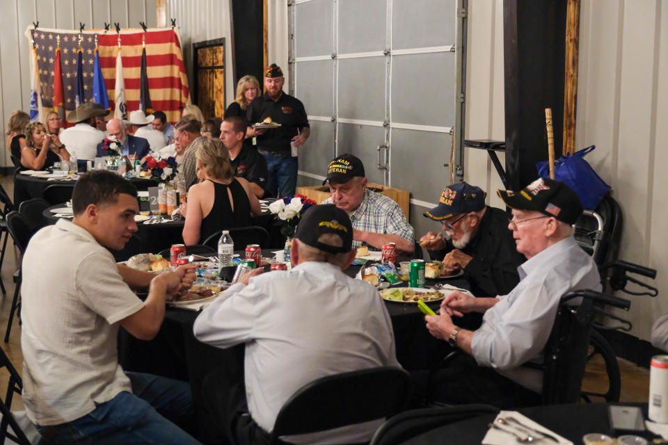 A group of Vietnam veterans share a conversation over a meal May 18 at the BOOM Adventures Armed Forces Day Banquet in Amarillo.