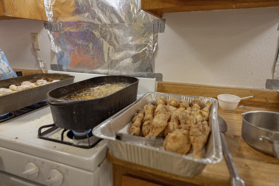 Fried chicken that is one of the many things visitors can expect to eat at the Springfield United Methodist Church's annual wild onion dinner, sits on the counter in Okemah, Okla., on April 6, 2024. The dinners center around the green onions that grow all over Oklahoma. (AP Photo/Brittany Bendabout)