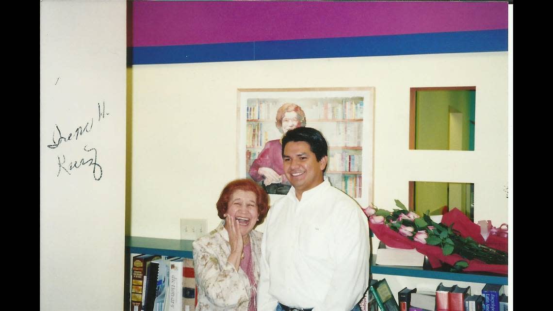 Irene H. Ruiz and Westside CAN Center board president Ezekiel A. Amador III stand in front of a watercolor portrait of Ruiz during the dedication of the Irene H. Ruiz Biblioteca de las Americas in 2006, five years after the branch opened in Kansas City’s West Side.