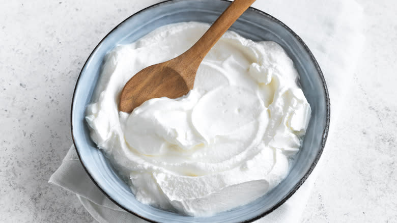 bowl of Greek yogurt with wooden spoon