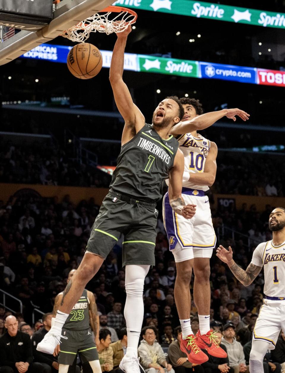 Minnesota Timberwolves forward Kyle Anderson dunks in front of Lakers guard Max Christie in the first half Sunday.