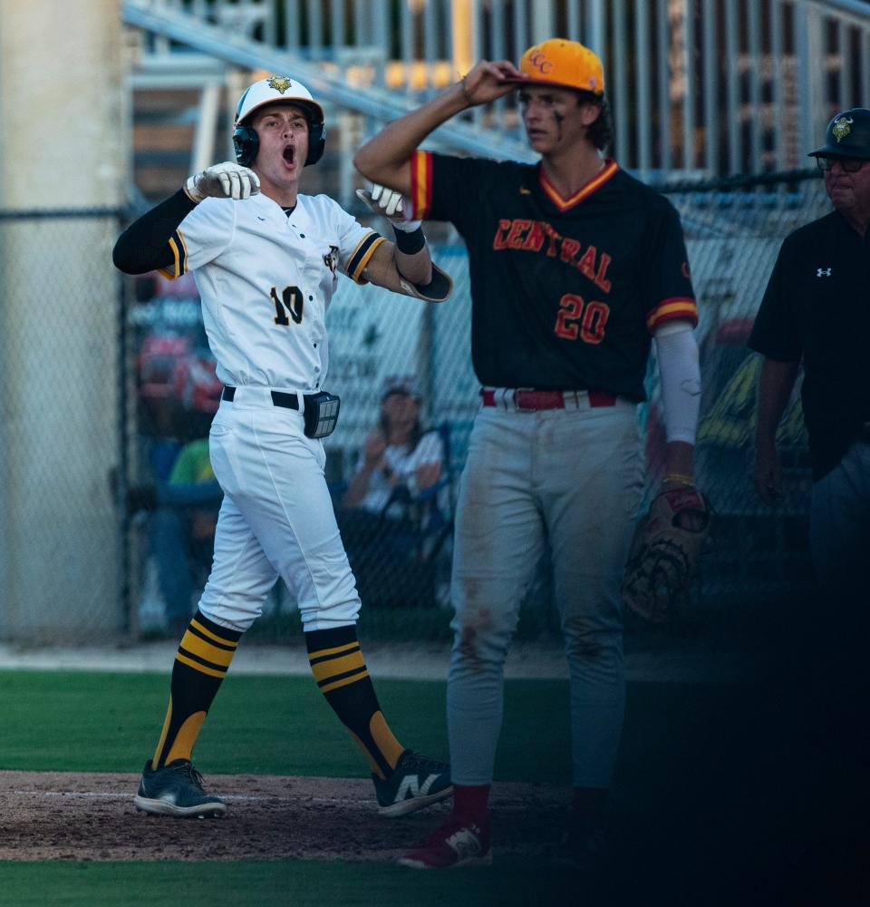 Maddix Simpson of the Bishop Verot baseball team celebrates a hit during a regional playoff game against Clearwater Central Catholic at Bishop Verot on Wednesday, May 8, 2024. Bishop Verot won 8-0 and moves on. On the right is Avery Shahriari of Clearwater Central Catholic.