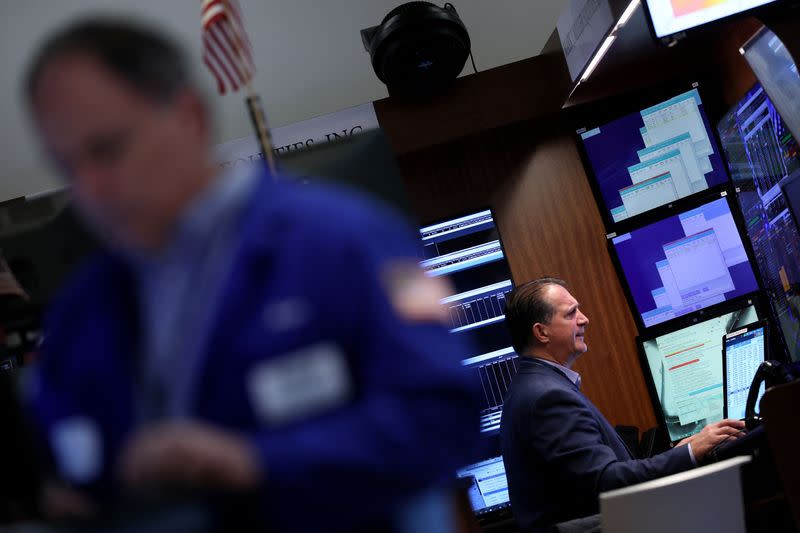 Traders work on the floor of the NYSE in New York