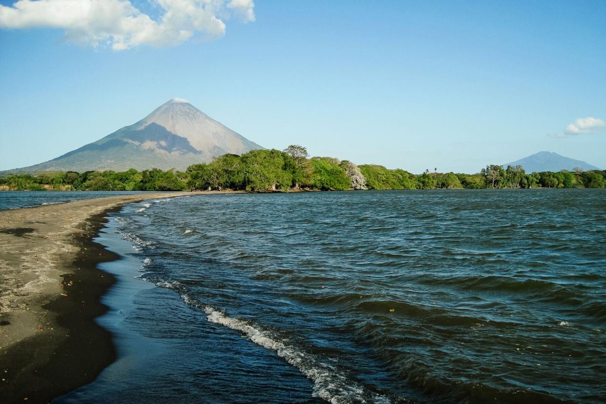 A beach in Managua in front of a volcano in Nicaragua