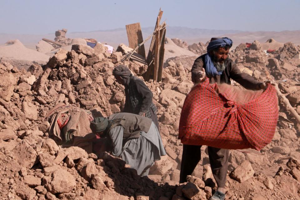 Afghan residents clear debris of damaged houses after earthquake in Nayeb Rafi village, Zendeh Jan district of Herat province (AFP/Getty)