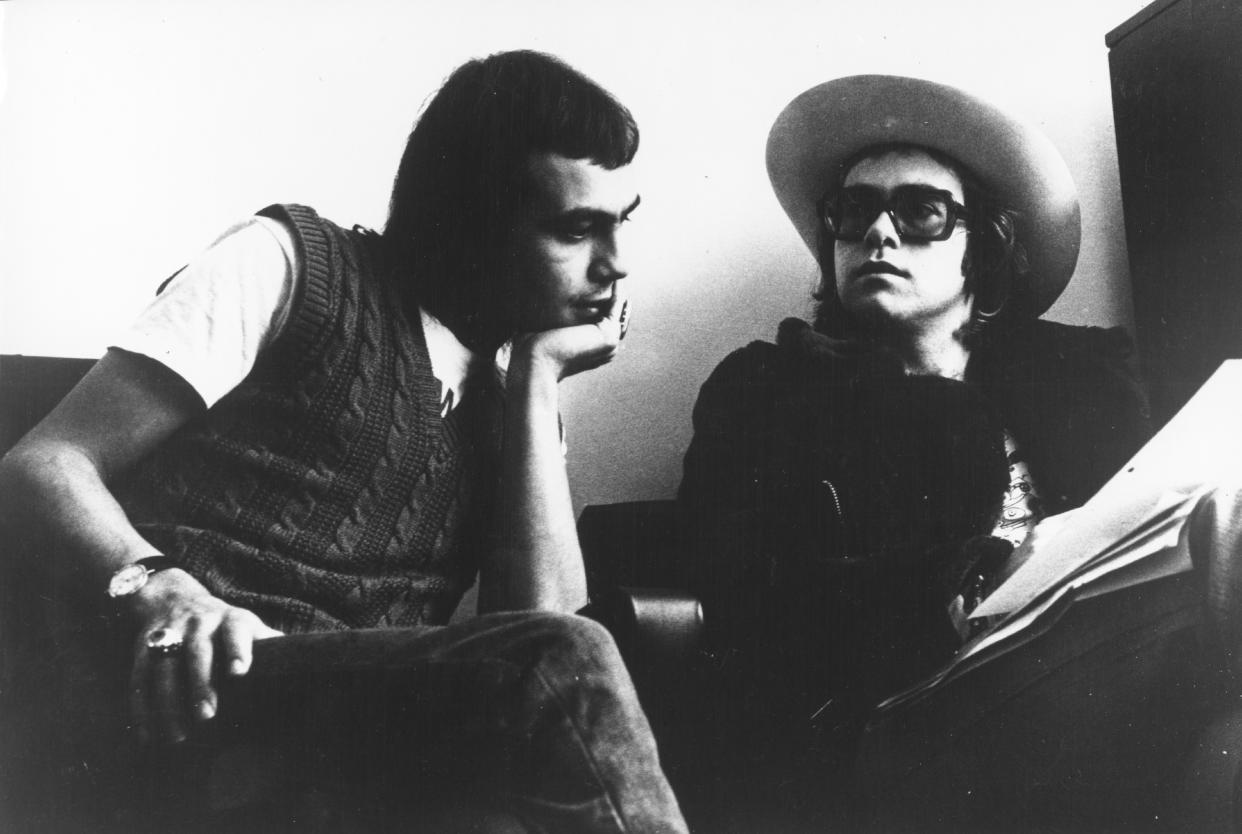 LONDON - CIRCA 1973: Pop singer Elton John and his lyricist Bernie Taupin (left) pose for a portrait in circa 1973 in London, England. (Photo by Michael Ochs Archives/Getty Images)