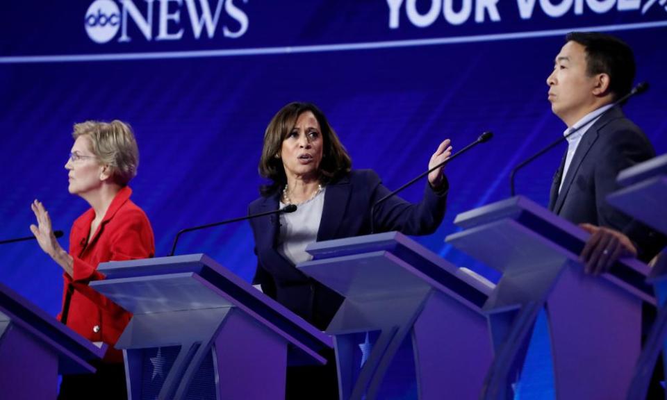 Kamala Harris makes a point flanked by Elizabeth Warren and Andrew Yang.