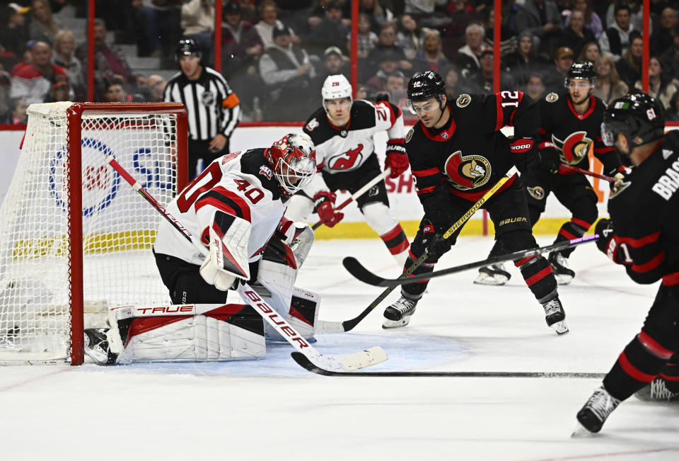 Ottawa Senators centre Derick Brassard (61) watches his shot on New Jersey Devils goaltender Akira Schmid (40) hit the back of the net during the second period of an NHL hockey game in Ottawa, Ontario, on Saturday, Nov. 19, 2022. (Justin Tang/The Canadian Press via AP)